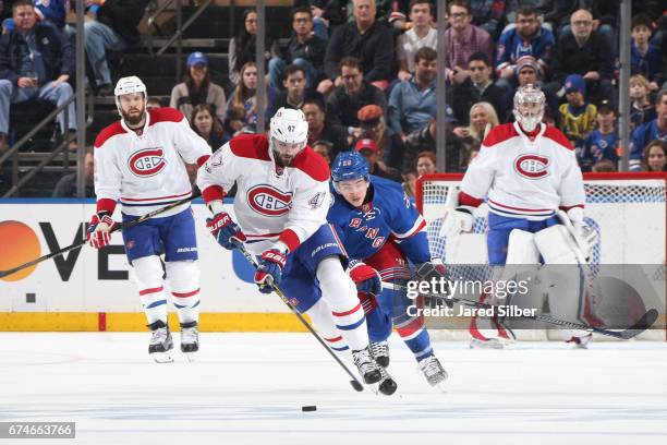 Alexander Radulov of the Montreal Canadiens skates with the puck against Jimmy Vesey of the New York Rangers in Game Six of the Eastern Conference...