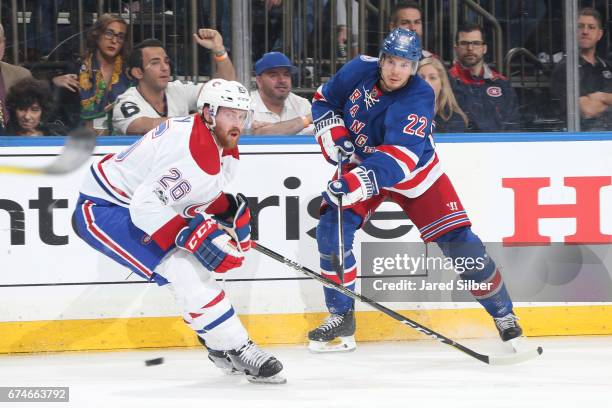 Nick Holden of the New York Rangers skates against Jeff Petry of the Montreal Canadiens in Game Six of the Eastern Conference First Round during the...