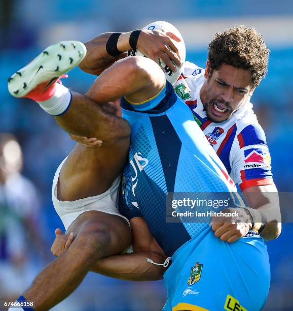 Dane Gagai of the Knights is tackled by Jarryd Hayne of the Titans during the round nine NRL match between the Gold Coast Titans and the Newcastle...