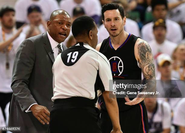 Head coach Doc Rivers of the Los Angeles Clippers and JJ Redick of the Clippers argue a second half call with official James Capers during their...