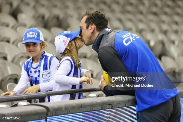 Todd Goldstein of the Kangaroos kisses one of his daughters during the round six AFL match between the North Melbourne Kangaroos and the Gold Coast...