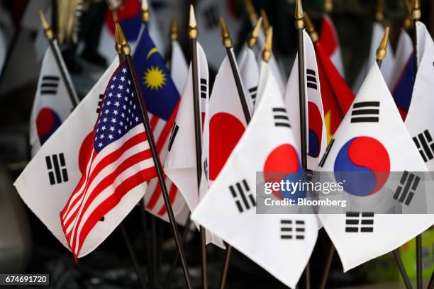 National flag, left, and South Korean national flags are displayed at a souvenir shop at the Imjingak pavilion near the demilitarized zone in Paju,...