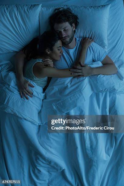 couple asleep embracing - above view of man sleeping on bed stock pictures, royalty-free photos & images