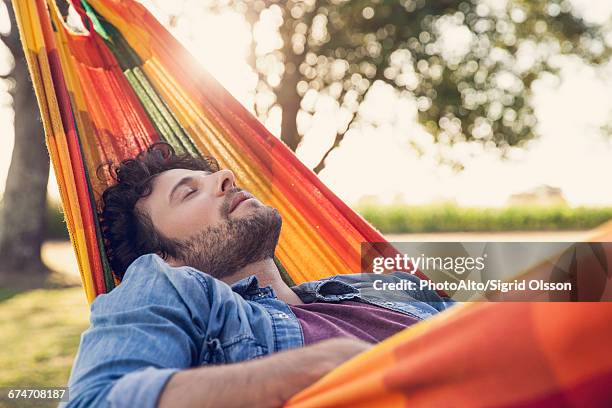 man napping in hammock - dozes stock pictures, royalty-free photos & images