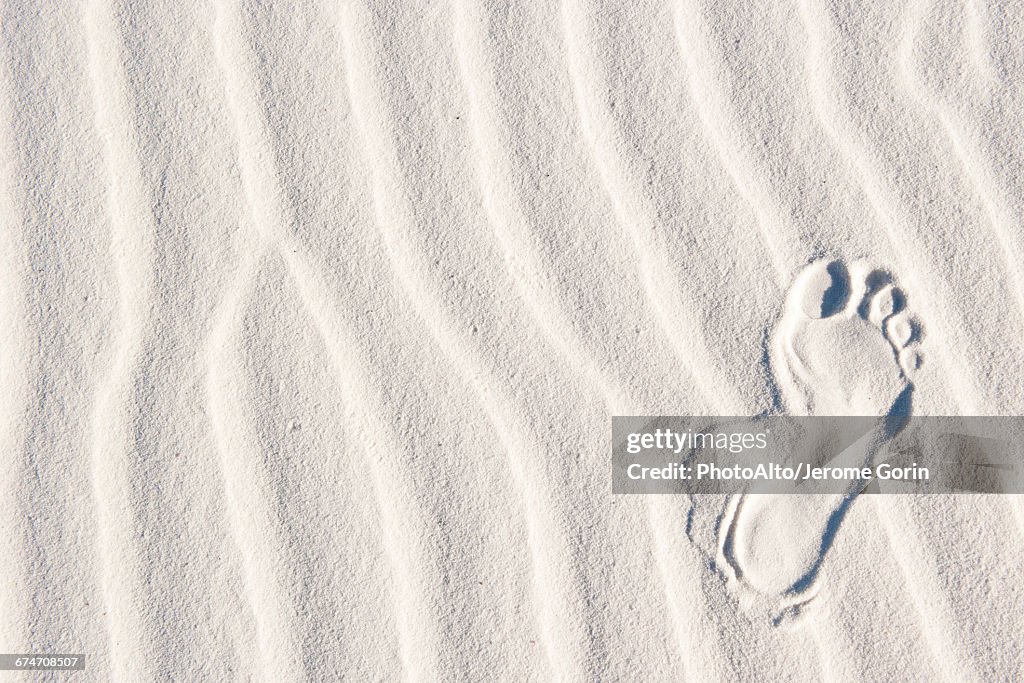 Footprint in white sand