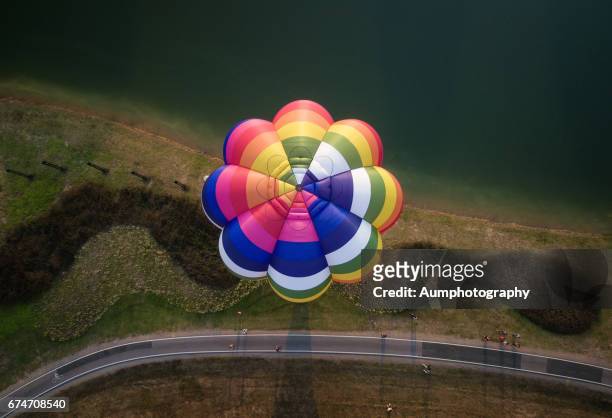 aerial view of colorful hot air balloon. - blowing balloon stock pictures, royalty-free photos & images