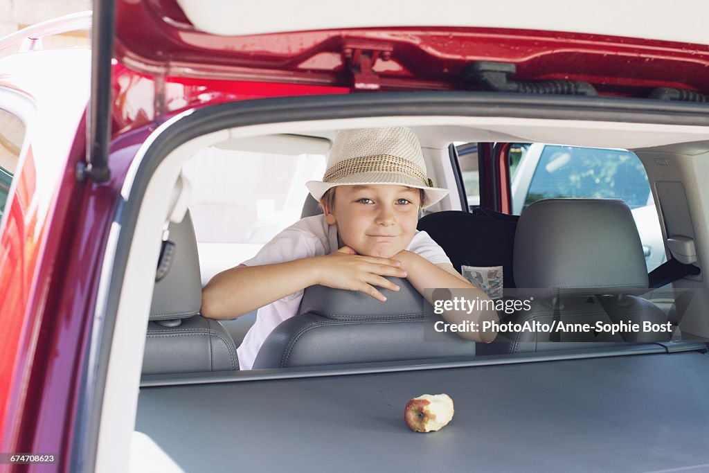 Boy looking out of back seat of car