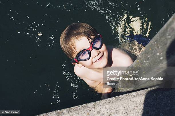 boy with goggles swimming in water - boy river looking at camera stock pictures, royalty-free photos & images