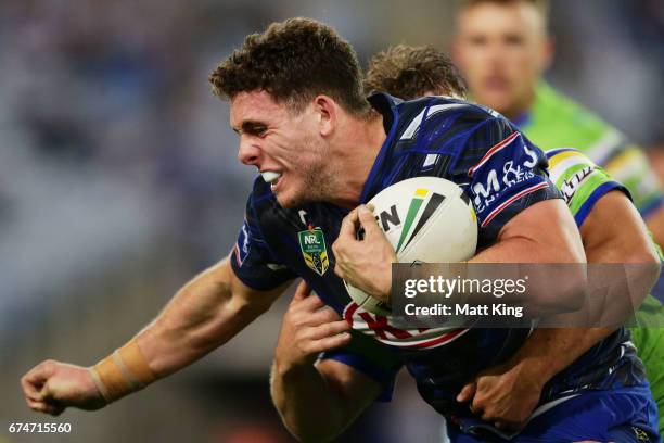 Adam Elliot of the Bulldogs is tackled during the round nine NRL match between the Canterbury Bulldogs and the Canberra Raiders at ANZ Stadium on...