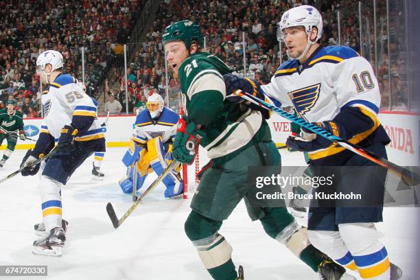 Scottie Upshall of the St. Louis Blues defends Ryan White of the Minnesota Wild in Game Five of the Western Conference First Round during the 2017...