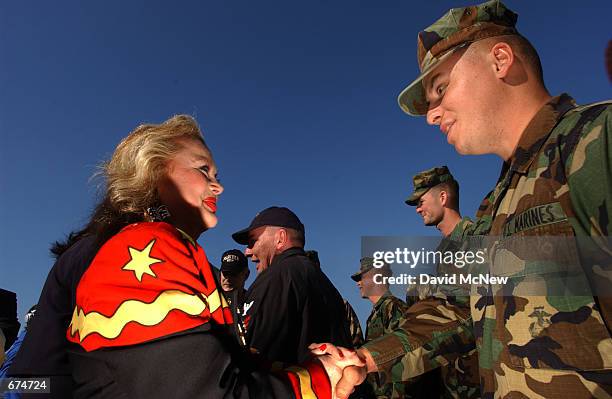 Actress Carol Conners shakes the hand of a Marine aboard the USS Ogden November 30, 2001 at the 32nd Street Naval Station in San Diego, CA. Several...