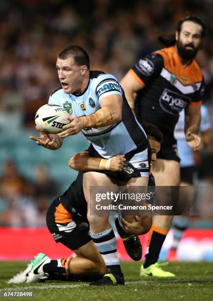 Paul Gallen of the Sharks passes during the round nine NRL match between the Wests Tigers and the Cronulla Sharks at Leichhardt Oval on April 29,...