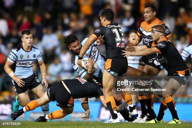 Andrew Fifita of the Sharks is tackled during the round nine NRL match between the Wests Tigers and the Cronulla Sharks at Leichhardt Oval on April...
