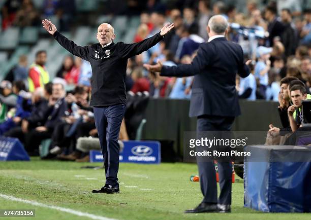 Kenny Lowe, manager of the Glory, has words with Graham Arnold, coach of of Sydney FC after a video referee decision during the A-League Semi Final...