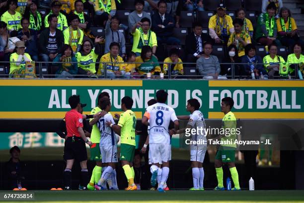 Kazuaki Mawatari of Tokushima Vortis receives a red card by referee Hiroyoshi Takayama after throwing the ball and pushing a ball boy during the...