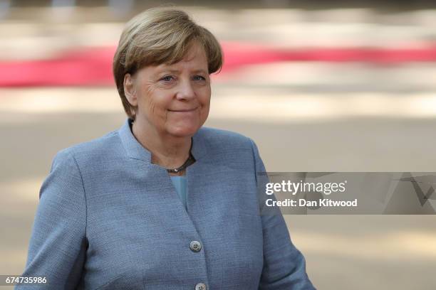 German Chancellor Angela Merkel speaks to the media as she arrives at the Council of the European Union ahead of an EU Council meeting on April 29,...