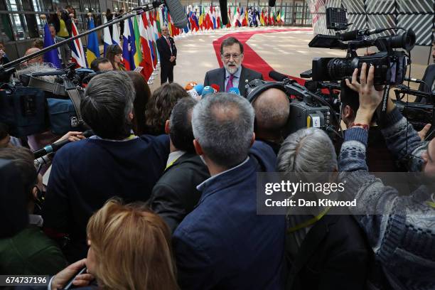 Spanish Prime Minister Mariano Rajoy speaks to the media as he arrives at the Council of the European Union ahead of an EU Council meeting on April...