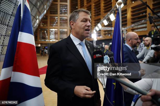 Romanian President Klaus Werner Iohannis speaks to the media as he arrives at the Council of the European Union ahead of an EU Council meeting on...