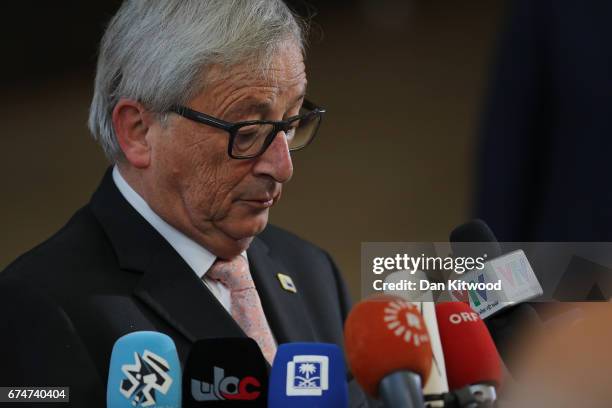 President of the European Commission Jean-Claude Juncker reacts as microphones are thrust towards him by the media as he arrives at the Council of...