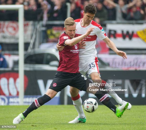 Cedric Teuchert of Nuernberg is challenged by Marcin Kaminski of Stuttgart during the Second Bundesliga match between 1. FC Nuernberg and VfB...