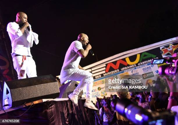 French singer Bedaya N'Garo Singuila aka Singuila jumps from the stage as he performs at the Festival des Musiques Urbaines d'Anoumabo on April 29 at...