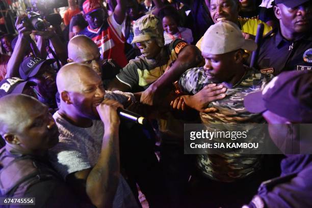 French singer Bedaya N'Garo Singuila aka Singuila sings in the middle of the audience as he performs at the Festival des Musiques Urbaines d'Anoumabo...