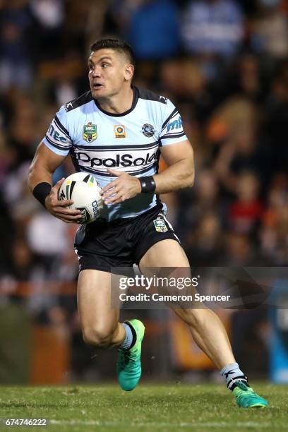 Chris Heighington of the Sharks runs the ball during the round nine NRL match between the Wests Tigers and the Cronulla Sharks at Leichhardt Oval on...