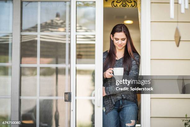 millennial female working from home - glass door stock pictures, royalty-free photos & images