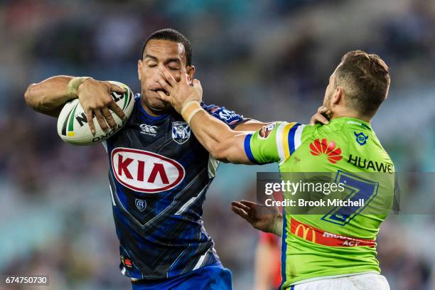 Will Hopoate of the Bulldogs is tackled by Aidan Sezer of the Raiders during the round nine NRL match between the Canterbury Bulldogs and the...