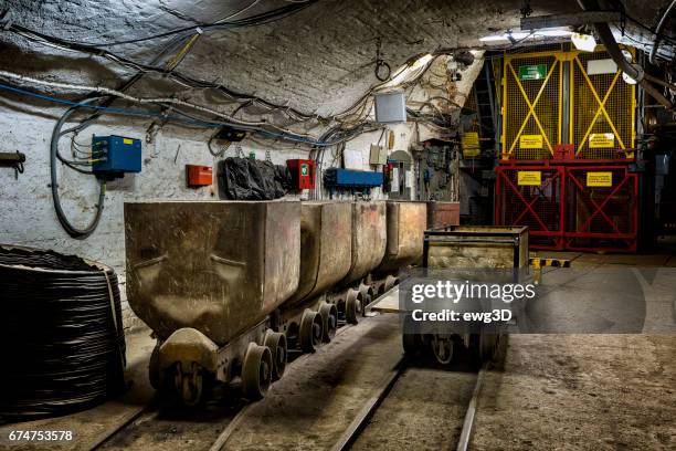 coal mine underground corridor with freight railroad cars and elevator mine shaft - mine elevator stock pictures, royalty-free photos & images