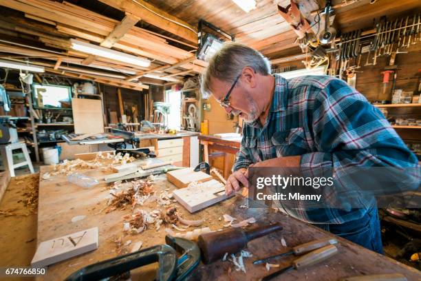 carpenter in his workshop carving wood with chisel - chisel stock pictures, royalty-free photos & images