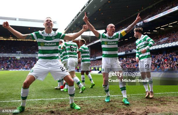 Mikael Lustig and Scott Brown of Celtic celebrate their team's third goal scored by Callum McGregor during the Ladbrokes Scottish Premiership match...