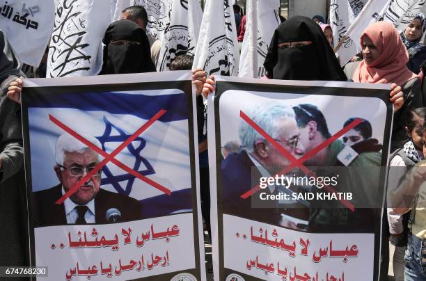 Palestinian supporters of Al-Ahrar movement, a network of former Fatah operatives, hold crossed out posters depicting Palestinian President Mahmoud...