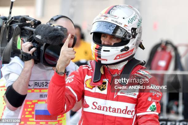 Pole position winner Ferrari's German driver Sebastian Vettel celebrates after the qualifying session for the Formula One Russian Grand Prix at the...