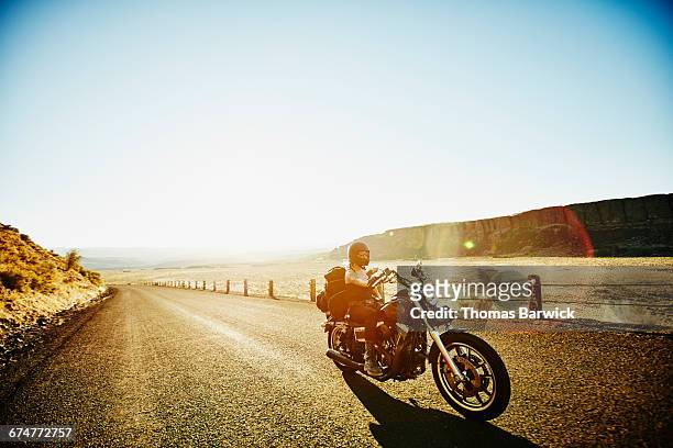 motorcyclist on road trip on summer evening - motorcycle rider stock pictures, royalty-free photos & images