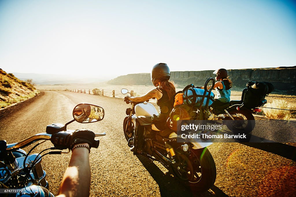 Friends on motorcycle road trip on summer evening