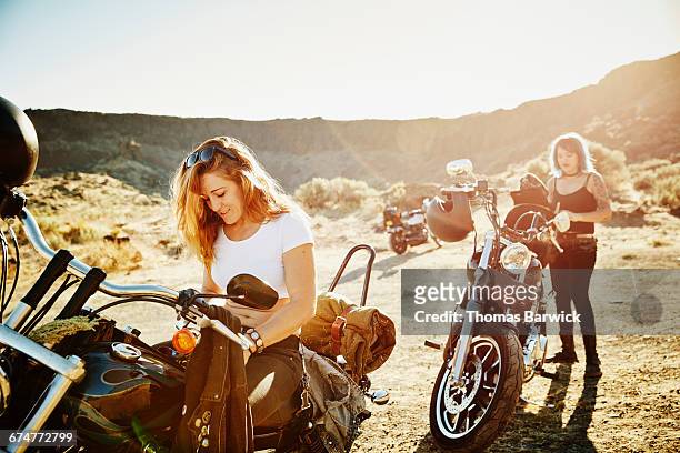 motorcyclists on road trip preparing to ride - biker helmet stock pictures, royalty-free photos & images