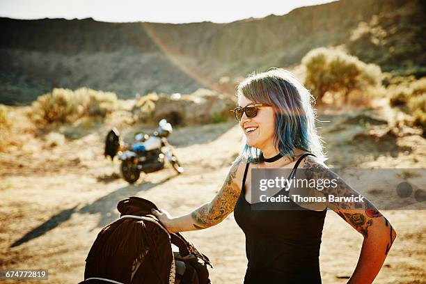 motorcyclist on road trip standing next to bike - motard photos et images de collection