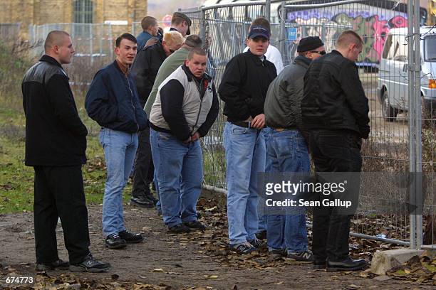 Right-wing demonstrators urinate on the sidelines of a march in central Berlin December 1 2001 to protest a current exhibition that details...