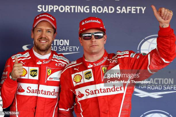 Top two qualifiers and team mates, Sebastian Vettel of Germany and Ferrari and Kimi Raikkonen of Finland and Ferrari in parc ferme during qualifying...