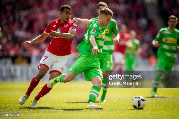 Nico Elvedi of Moenchengladbach and Robin Quaison of Mainz battle for the ball during the Bundesliga match between 1. FSV Mainz 05 and Borussia...