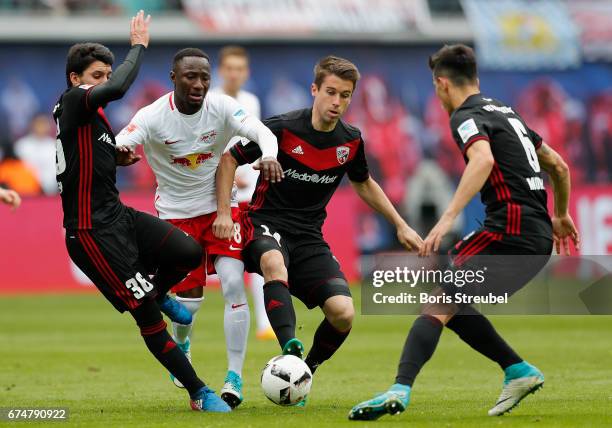 Naby Keita of RB Leipzig is challenged by Almog Cohen , Stefan Lex and Alfredo Morales of FC Ingolstadt 04 durin the Bundesliga match between RB...