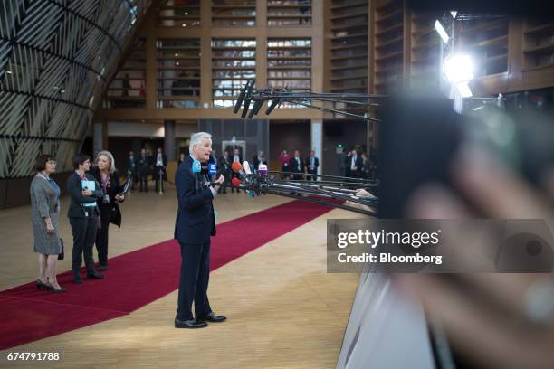 Michel Barnier, chief negotiator for the European Union , talks to members of the media as he arrives for a European Union leaders emergency Brexit...