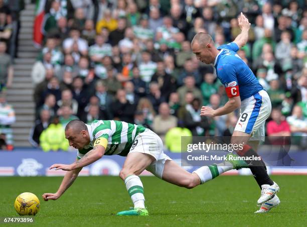 Scott Brown of Celtic is tackled by Kenny Miller of Rangers during the Ladbrokes Scottish Premiership match between Rangers FC and Celtic FC at Ibrox...