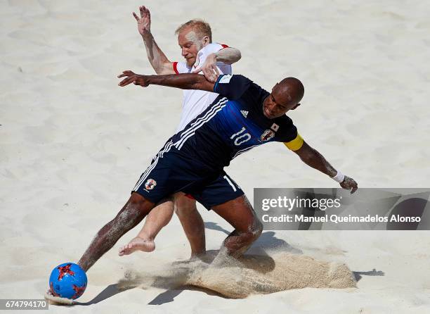 Piotr Klepczarek of Poland competes for the ball with Ozu Moreira of Japan during the FIFA Beach Soccer World Cup Bahamas 2017 group D match between...