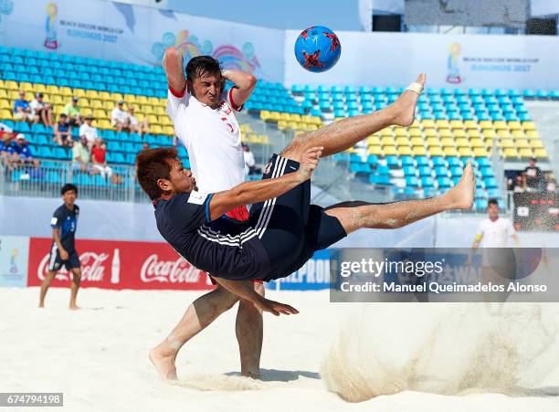 Takuya Akaguma of Japan attempts a scissor kick shot on goal in front Tomasz Lenart of Poland during the FIFA Beach Soccer World Cup Bahamas 2017...