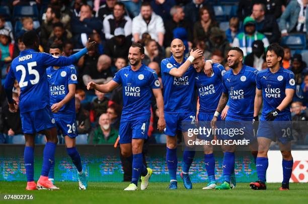 Leicester City's English striker Jamie Vardy is congratulated after scoring the opening goal during the English Premier League football match between...