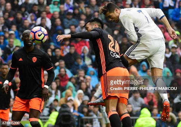 Real Madrid's Portuguese forward Cristiano Ronaldo heads the ball to score a goal during the Spanish league football match Real Madrid CF vs Valencia...