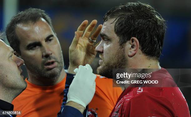 Lions Andries Ferreira receives treatment on the sidelines during the Super Rugby match between Australias Western Force and South Africas Lions in...