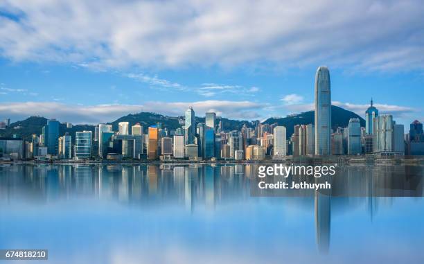 landscape city view of victoria harbour in hong kong with reflection - hong kong harbour stockfoto's en -beelden